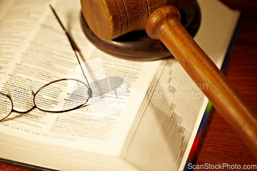 Image of The meaning of justice. An open book with a gavel and block - justice.