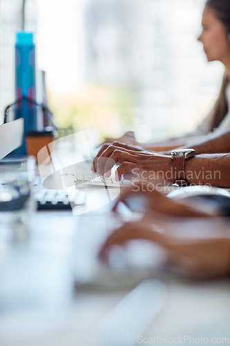 Image of Finding solutions to your problems. Cropped shot of a group of workers sitting at their desk.