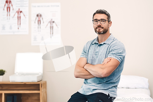 Image of Helping you heal is my job. Portrait of a handsome mature male physiotherapist posing with his arms folded in his office.