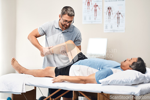 Image of Rehabilitation is a long and important journey to full recovery. Shot of a senior man going through rehabilitation with his physiotherapist.