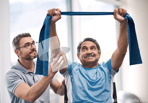 Image of Hes raising the bar today. Shot of a senior man exercising with a resistance band during a rehabilitation session with his physiotherapist.