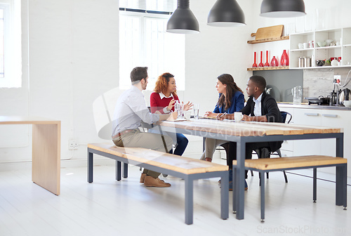 Image of Lets get down to business. Full length shot of a group of businesspeople in a meeting.