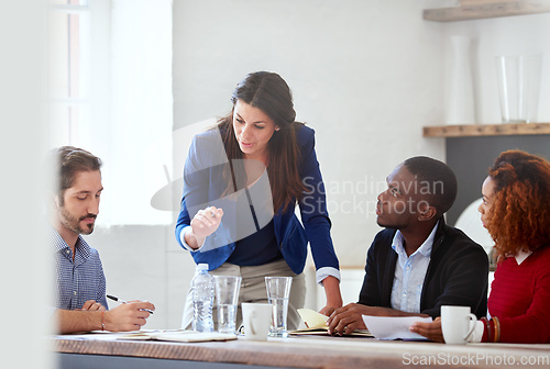 Image of Listen to what Im saying. Cropped shot of a young businesswoman addressing her colleagues during a business meeting.