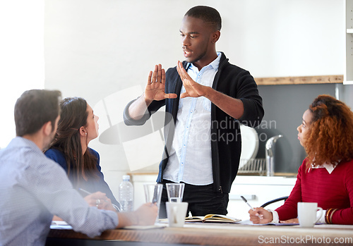 Image of Take a step back.... Cropped shot of a young businessman addressing his colleagues during a business meeting.