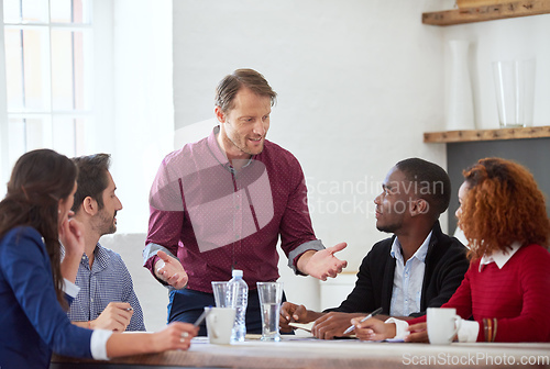 Image of So thats my plan. Cropped shot of a handsome businessman addressing his colleagues during a business meeting.