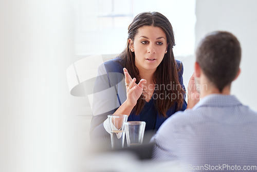 Image of Lets review this. Cropped shot of a young businesswoman having a one-on-one meeting with an employee.