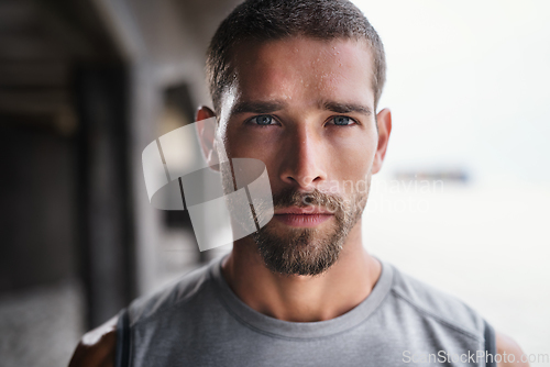 Image of Hes not playing ant games about his fitness. Portrait of a handsome young sportsman looking serious while exercising outdoors.