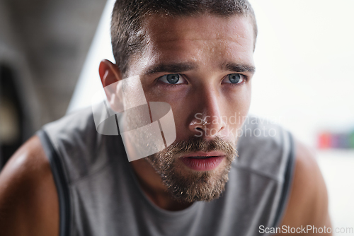 Image of Keep your eyes locked in on the prize. Shot of handsome young sportsman taking a break while exercising outdoors.