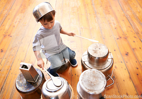 Image of Kids rock. Shot of an adorable little boy drumming on pots and pans.