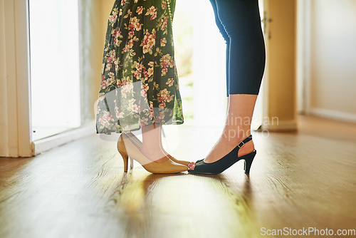 Image of Its a bond for life. Cropped shot of a mother and her little daughter wearing high heels at home.