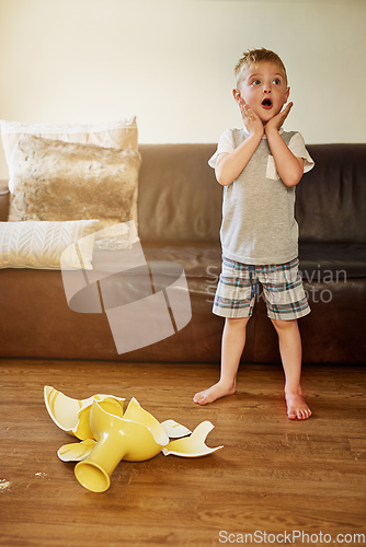 Image of Mom is going to be so mad about this. Shot of a little boy looking shocked after breaking a vase at home.