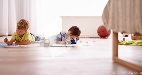 Image of Letting their imaginations free. Shot of two young boys painting pictures at home.