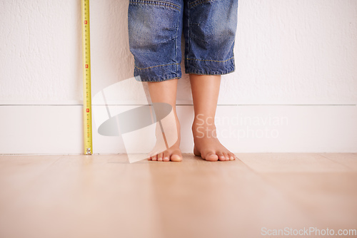 Image of Getting taller by the day. Cropped shot of a young boy standing next to a tape measure.
