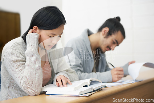 Image of This test could change their lives for the worse or for the better.... Image of two students sitting in a lecture hall and studying for exams.