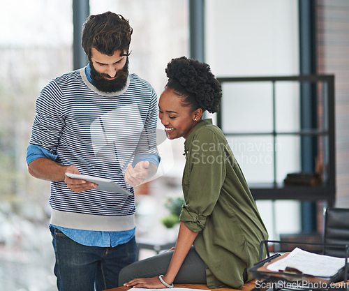 Image of I use this app to schedule all my appointments. Cropped shot of two creative businesspeople looking at something on a tablet.