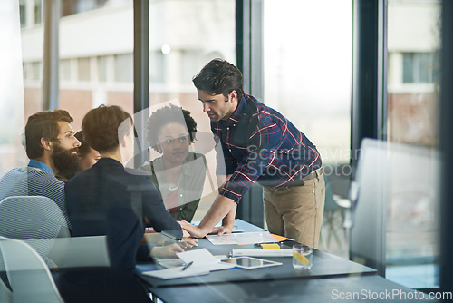 Image of This project has really brought them together as a team. Shot of a creative businessman leading his colleagues in a meeting.