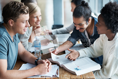 Image of Cramming before an exam. A group of college students sitting together and studying.