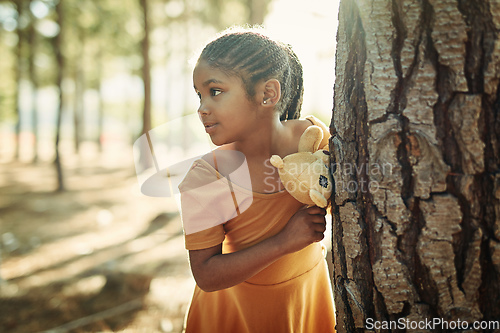 Image of If we go out to the woods today.... Shot of a little girl playing in the woods with her teddybear.