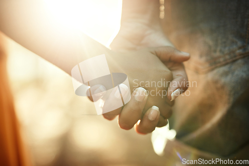 Image of Their bond is too precious. Closeup shot of an adult holding a childs hand outside.