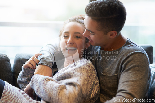 Image of Weekends are best when were together. Shot of an affectionate young couple relaxing on the sofa at home.
