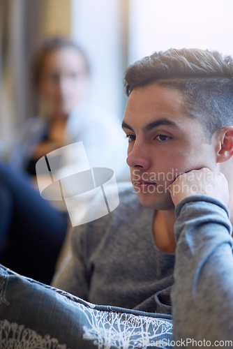 Image of Hes not in the mood. Shot of a young man looking despondent after a fight with his girlfriend.