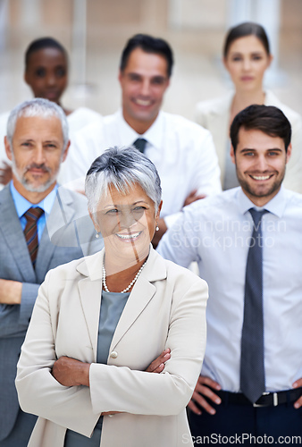 Image of Corporate excellence Check. Portrait of a smiling businesswoman surrounded by a group of her colleagues.