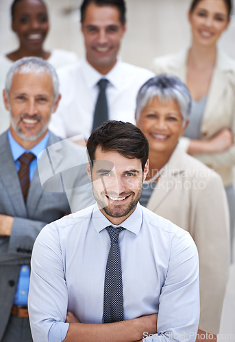 Image of Why settle for mediocre when you can have amazing. Portrait of a smiling businessman surrounded by a group of his colleagues.