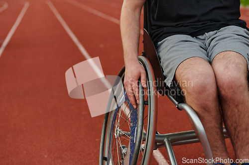 Image of Close up photo of a person with disability in a wheelchair training tirelessly on the track in preparation for the Paralympic Games