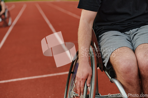 Image of Close up photo of a person with disability in a wheelchair training tirelessly on the track in preparation for the Paralympic Games