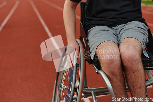 Image of Close up photo of a person with disability in a wheelchair training tirelessly on the track in preparation for the Paralympic Games