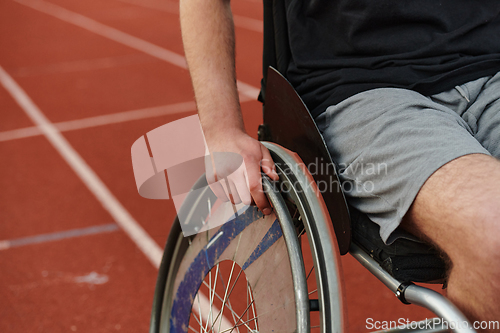 Image of Close up photo of a person with disability in a wheelchair training tirelessly on the track in preparation for the Paralympic Games