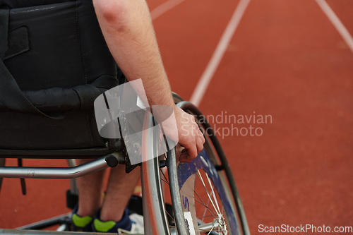 Image of Close up photo of a person with disability in a wheelchair training tirelessly on the track in preparation for the Paralympic Games