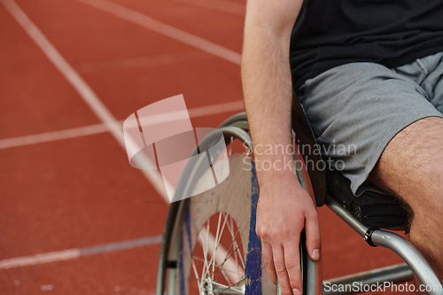 Image of Close up photo of a person with disability in a wheelchair training tirelessly on the track in preparation for the Paralympic Games