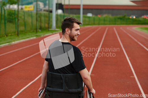 Image of A person with disability in a wheelchair training tirelessly on the track in preparation for the Paralympic Games