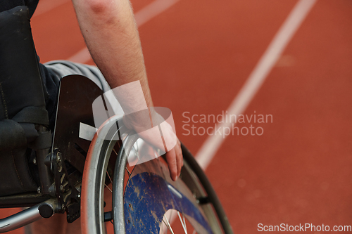 Image of Close up photo of a person with disability in a wheelchair training tirelessly on the track in preparation for the Paralympic Games