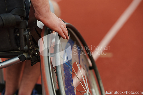 Image of Close up photo of a person with disability in a wheelchair training tirelessly on the track in preparation for the Paralympic Games