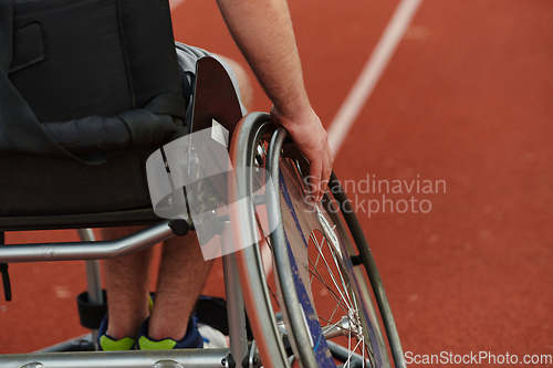 Image of Close up photo of a person with disability in a wheelchair training tirelessly on the track in preparation for the Paralympic Games