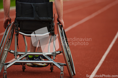 Image of Close up photo of a person with disability in a wheelchair training tirelessly on the track in preparation for the Paralympic Games