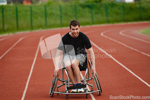 Image of A person with disability in a wheelchair training tirelessly on the track in preparation for the Paralympic Games