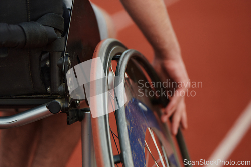 Image of Close up photo of a person with disability in a wheelchair training tirelessly on the track in preparation for the Paralympic Games