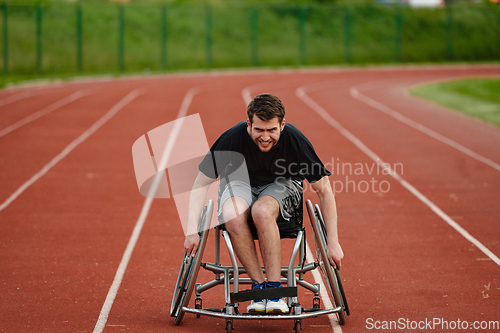 Image of A person with disability in a wheelchair training tirelessly on the track in preparation for the Paralympic Games