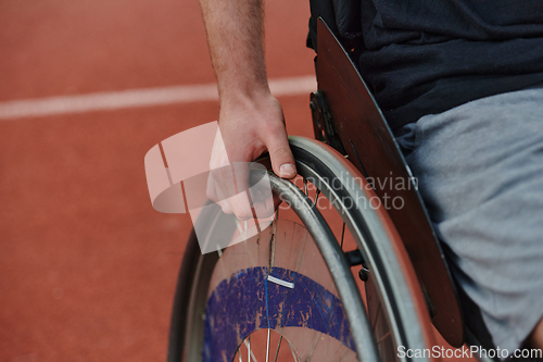 Image of Close up photo of a person with disability in a wheelchair training tirelessly on the track in preparation for the Paralympic Games