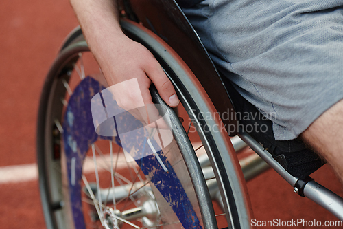 Image of Close up photo of a person with disability in a wheelchair training tirelessly on the track in preparation for the Paralympic Games