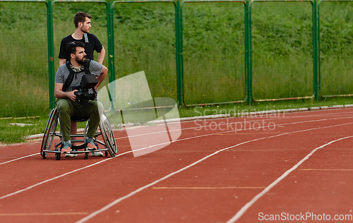 Image of A cameraman filming the participants of the Paralympic race on the marathon course