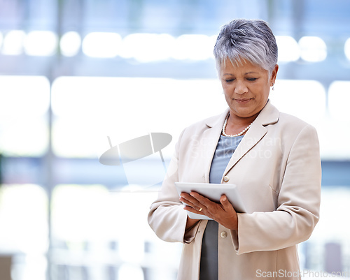 Image of Finance at her fingertips. Shot of a mature business woman holding a digital tablet.