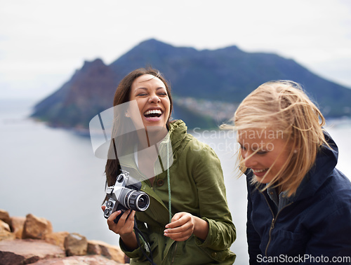 Image of You shouldve seen your face in that last shot. A shot of two young women laughing on the side of the road during their trip.