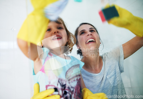 Image of Making chores fun. Shot of a mother and daughter doing chores together at home.