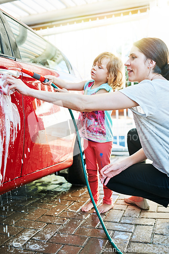 Image of Spending some quality time together. Shot of a mother and daughter washing a car together.