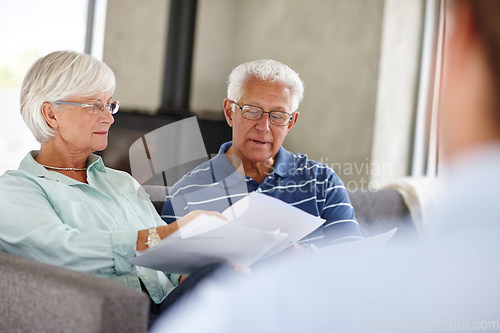 Image of Save a penny, earn a penny. Over-the-shoulder shot of a financial advisor meeting with a senior couple at their home.