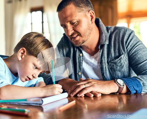 Image of Dads on standby to help with homework. Shot of a father helping his son with his homework.